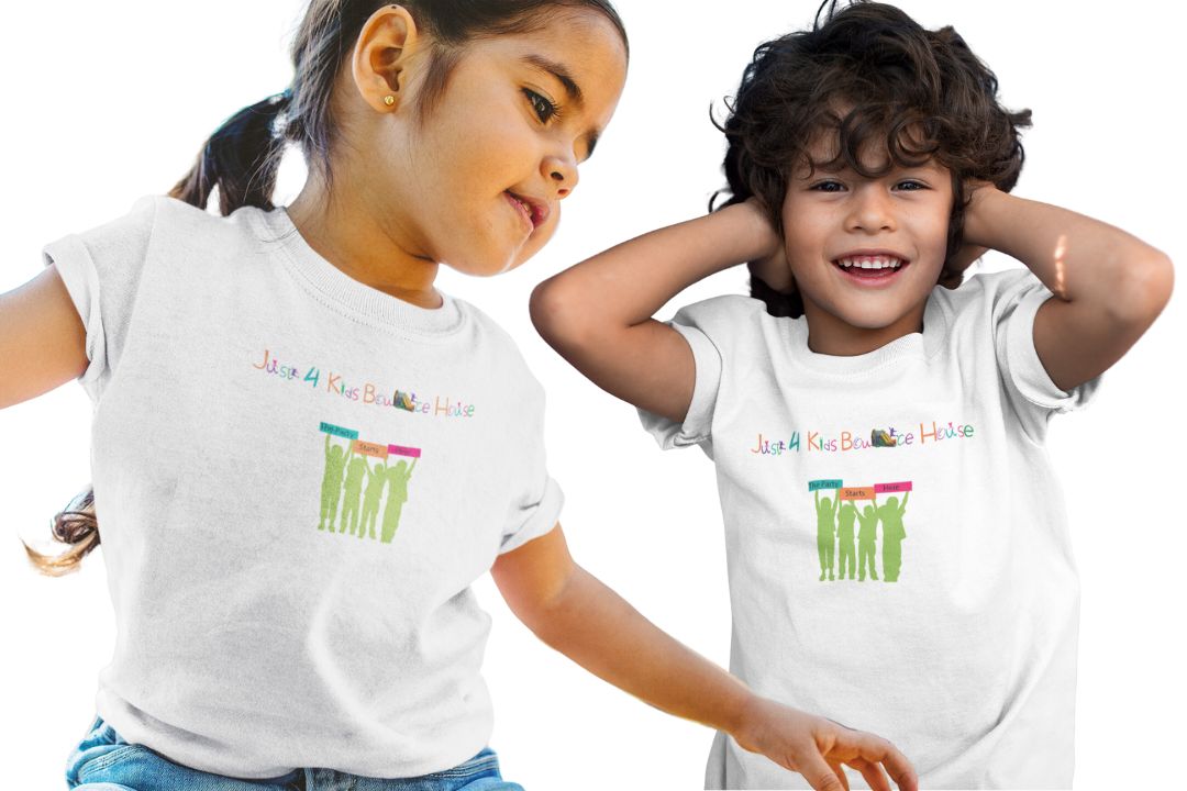 Two children are happily wearing branded t-shirts with the logo "just 4 kids bounce house. " the design features silhouettes of children holding colorful signs that say "the party starts here," capturing the fun and playful spirit of the bounce house rental brand.